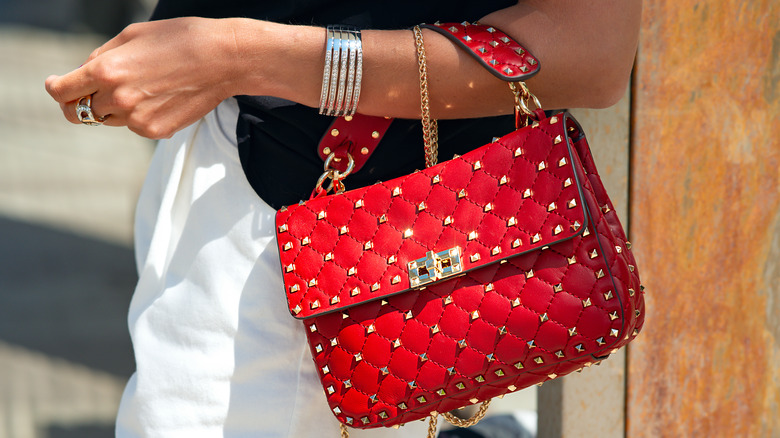 Red quilted and studded handbag