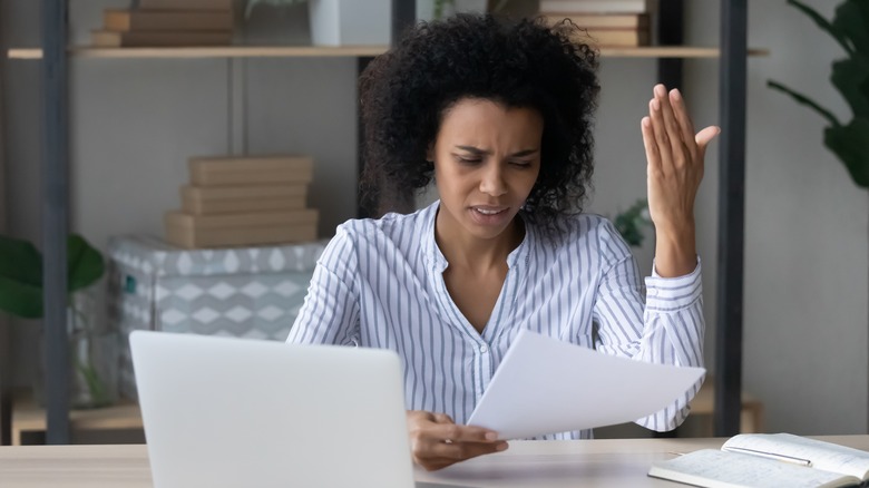 upset woman reading letter