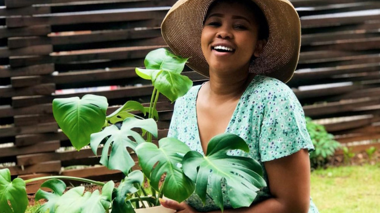 beautiful young Black woman smiling in garden