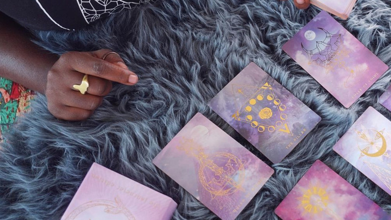 Black woman reading tarot spread