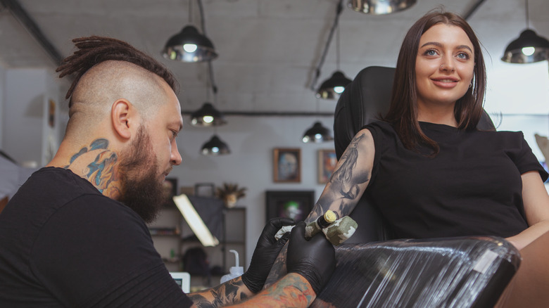 woman getting cover-up tattoo