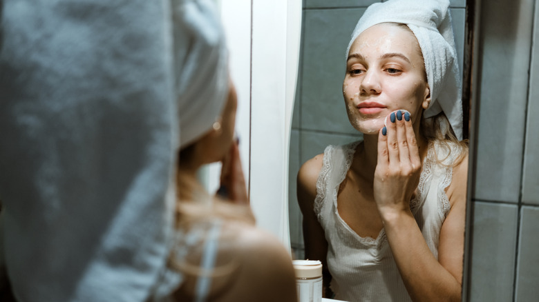 Woman washing her face in the bathroom