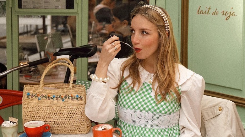 woman sitting at cafe eating 