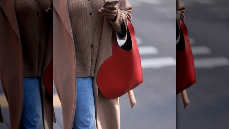 woman holding heart-shaped bag