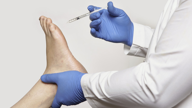 Doctor injects foot Botox