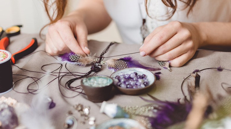 person making jewelry