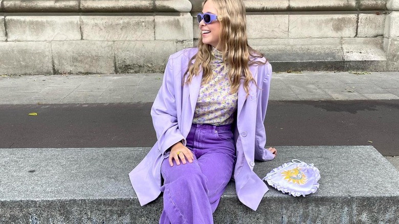 stylish blonde woman wearing purple