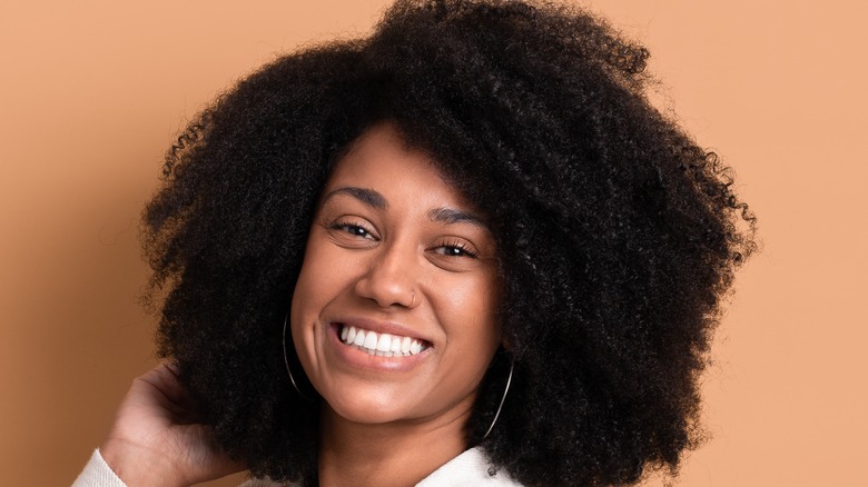 woman with curly hair smiling