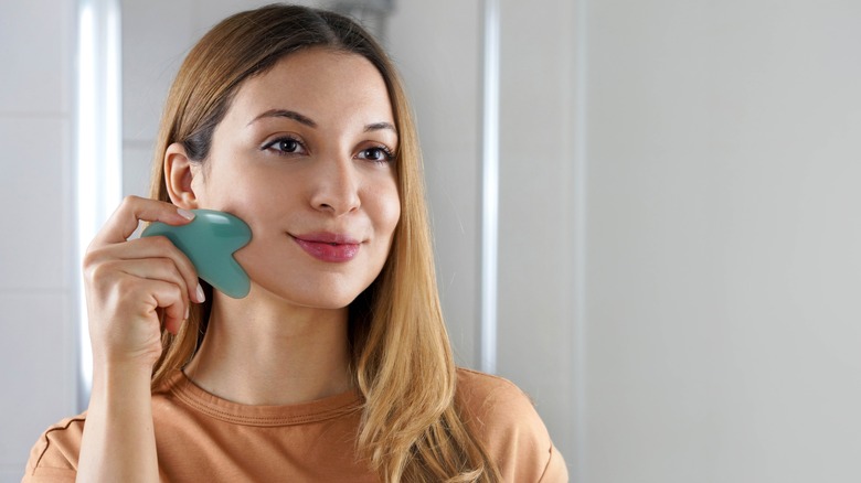 woman using gua sha