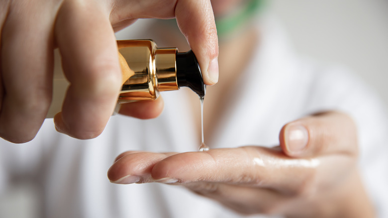 woman squeezing gel onto hand