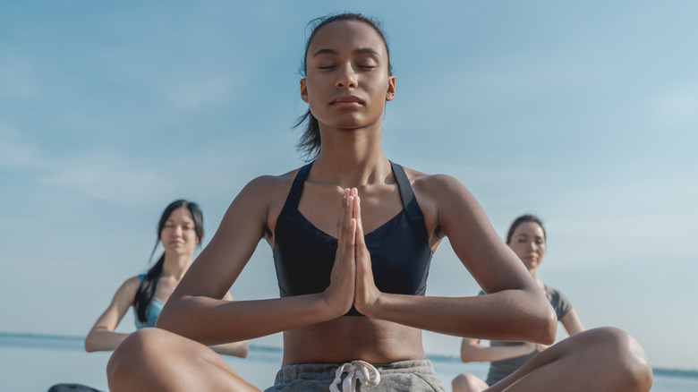 group of women meditating