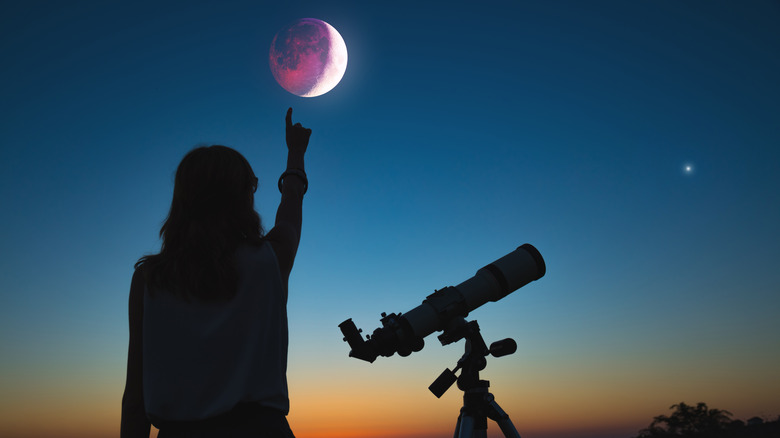 person watching lunar eclipse