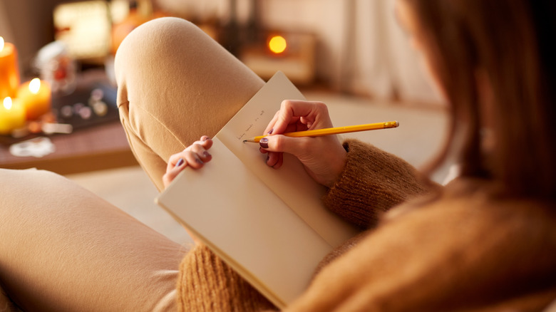 woman writing in her journal 