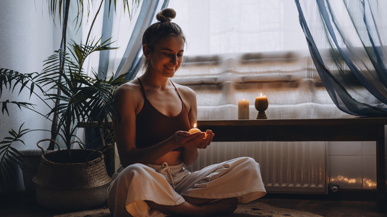 woman manifesting with candles