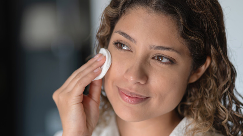 Woman applying facial toner