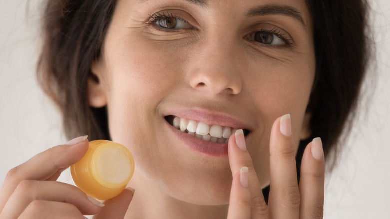 Model applying lip balm