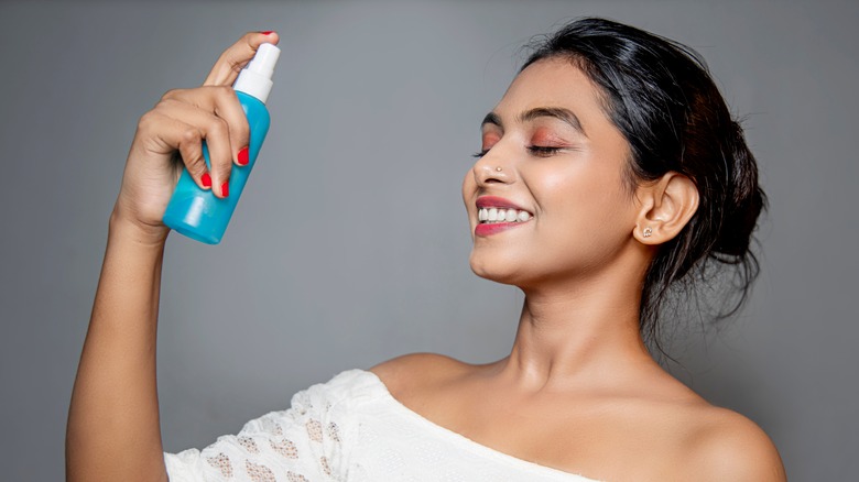 woman applying setting spray