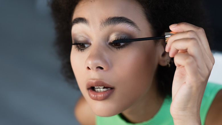 woman applying mascara