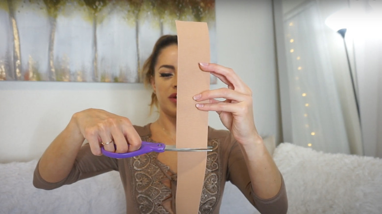 woman cutting body tape 