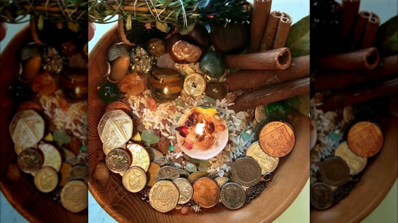 Money bowl with lit candle