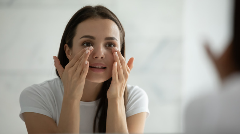 Woman applying eye cream