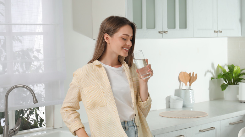 Woman drinking a glass of water.