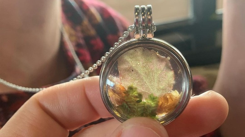 person wearing a glass locket