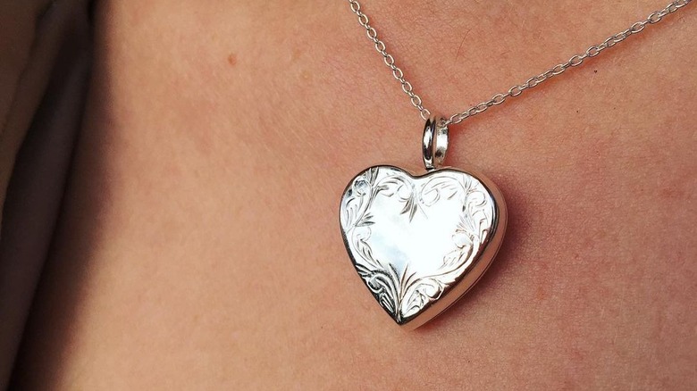 person wearing a heart locket