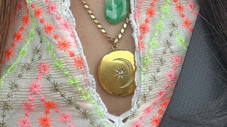 person wearing a gold locket