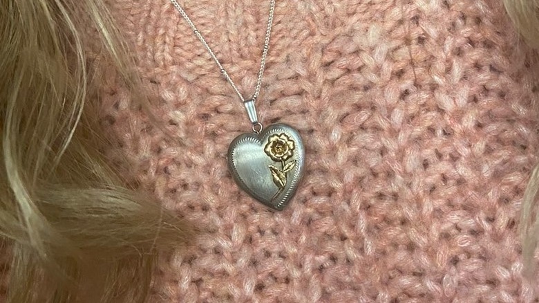 person wearing a heart locket