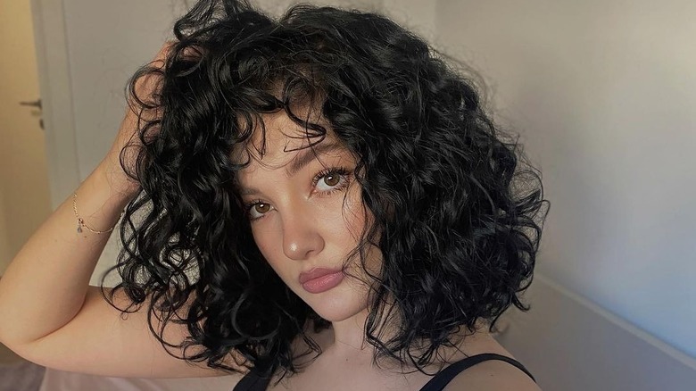 Short curly hair with curtain bangs