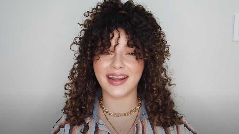 hairstyle with curly curtain bangs