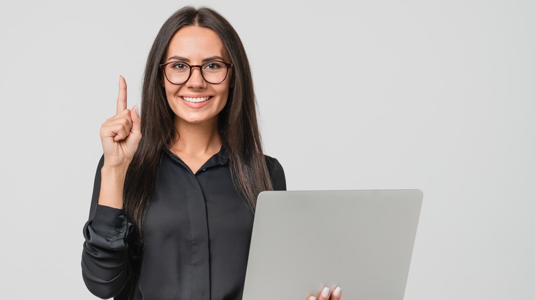 woman holding laptop