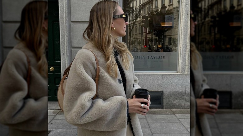 girl wearing fluffy coat and dainty jewelry