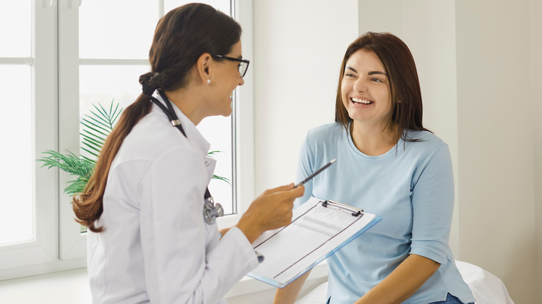 young woman speaking to doctor