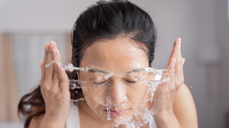 woman rinsing face