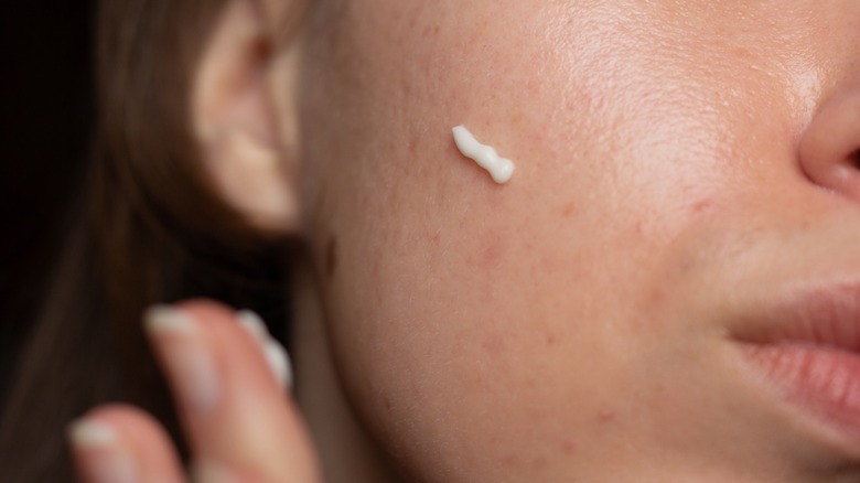 woman using retinol cream