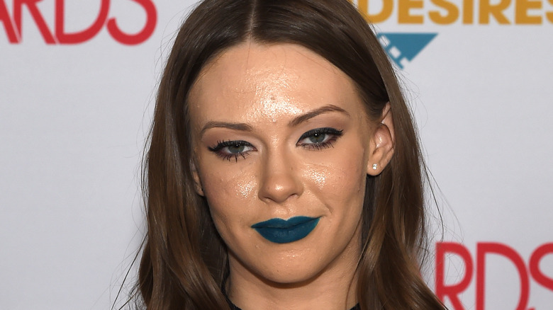 Woman with dark teal lipstick