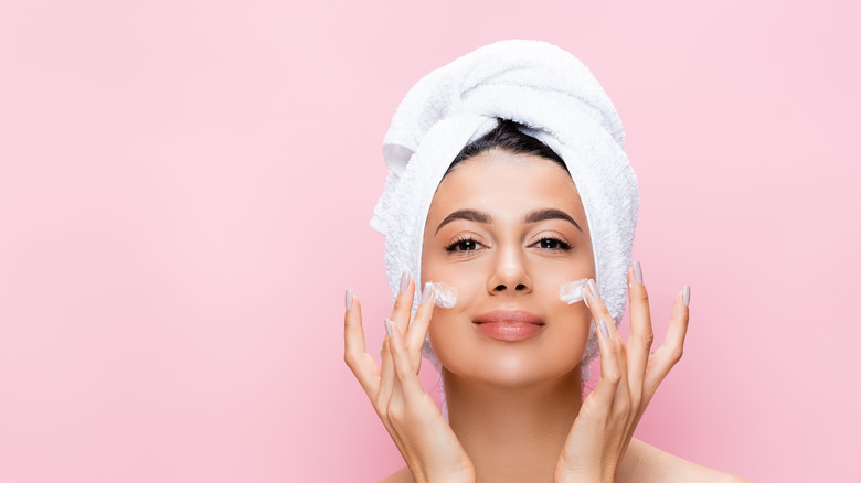 woman applying face cream