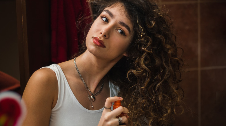 woman applying leave-in conditioner