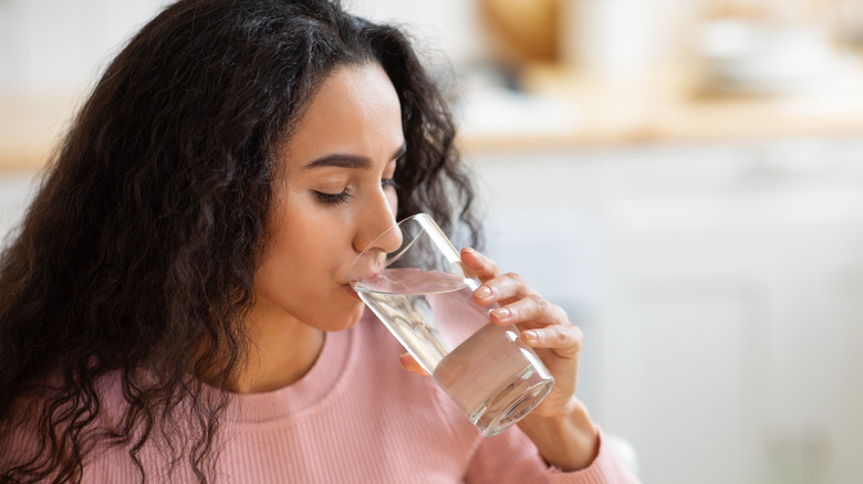 Woman drinking from glass of water