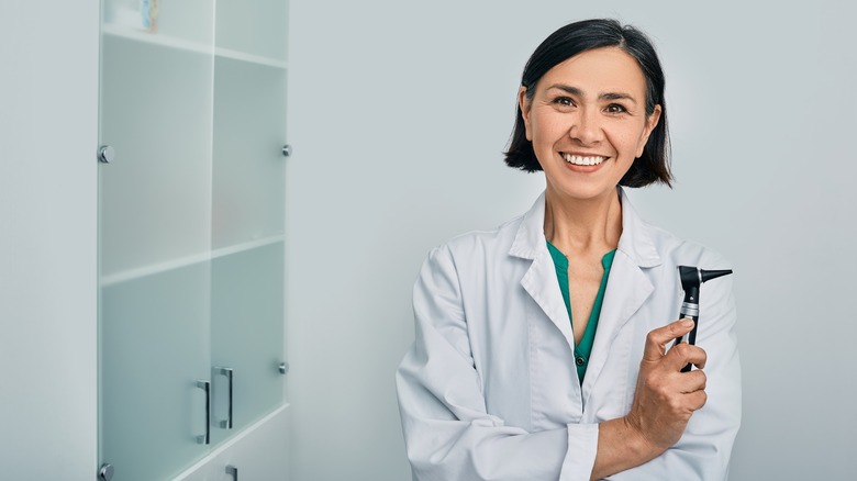 audiologist doctor holding ear instrument