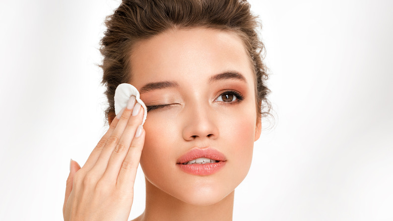 woman removing eye makeup