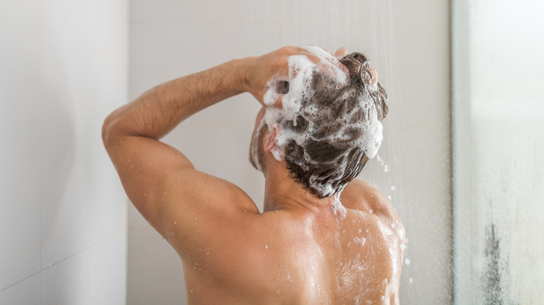 Man washing hair in shower