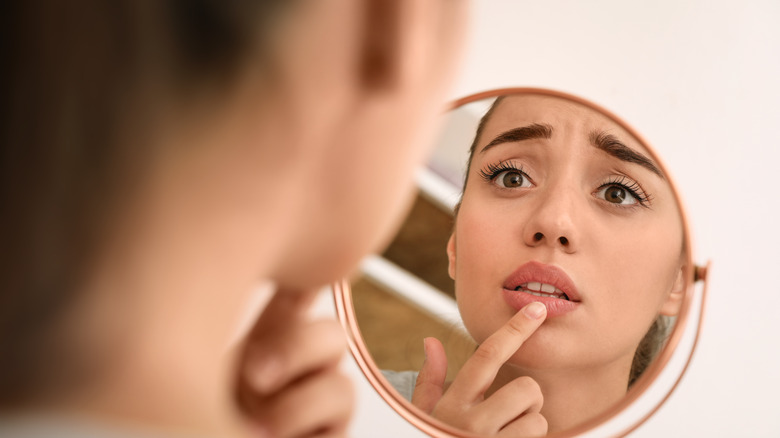 woman looking at chapped lips