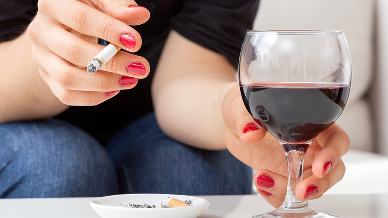 woman drinking wine and smoking
