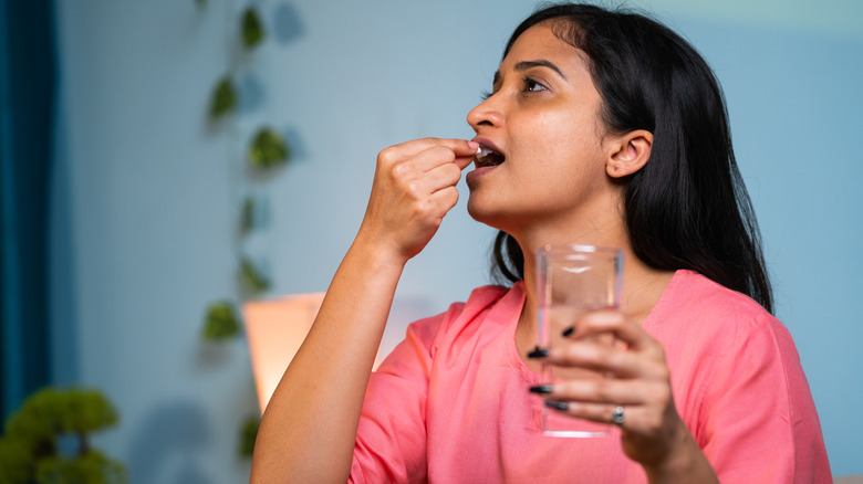 woman taking pill 