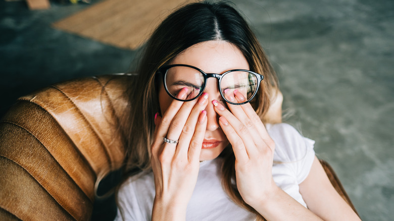 Young woman rubbing her eyes