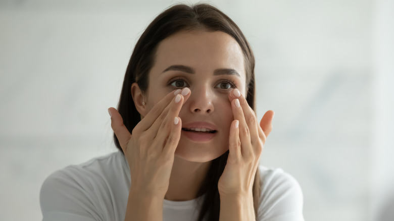 Woman applying eye cream