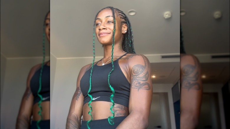 Smiling Sha'Carri Richardson with green hair